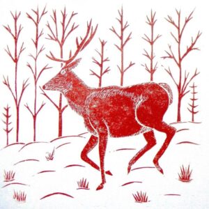 A hand printed lino cut of a reindeer in a winter woodland landscape printed in a single colour, red.
